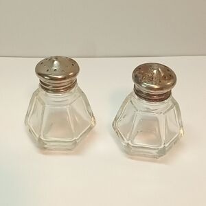 Vintage clear glass small salt and pepper shakers.